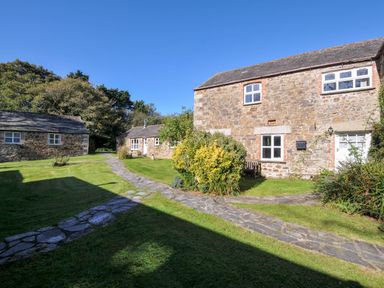A view of buildings and pathway in a garden at The Granary Rock