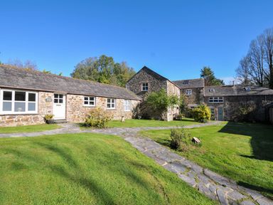 An outdoor view of stone buildings and grass at The Granary Rock