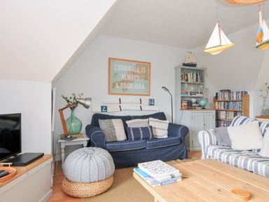 A living room with a blue sofa and wooden coffee table at Rocklings in Rock