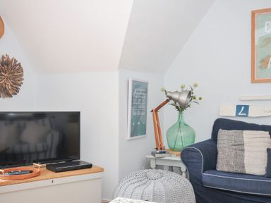 A living room with a television and a sofa at Rocklings in Rock
