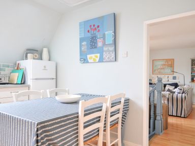 A kitchen with a dining table and chairs at Rocklings in Rock
