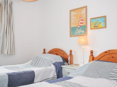 A bedroom with two beds and wall art in Rocklings, Rock