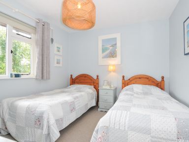 A bedroom with two single beds and a bedside table at Rocklings in Rock