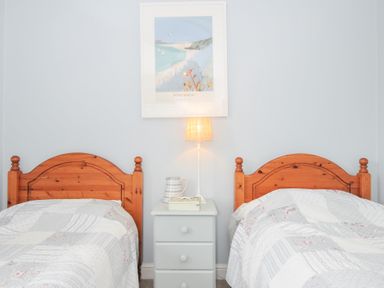 A bedroom with two beds and a bedside table at Rocklings in Rock