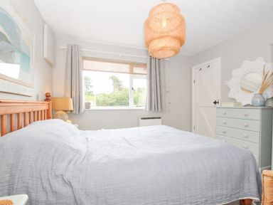A bedroom with a wooden bed and window at Rocklings in Rock