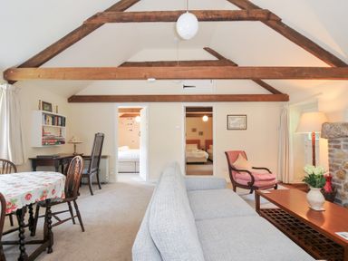 A living room with a sofa and table at Mill Pond in Rock