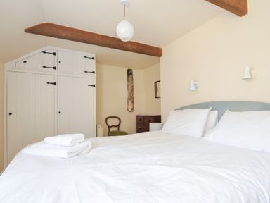 A bedroom with a bed and wardrobe at Mill Pond Rock