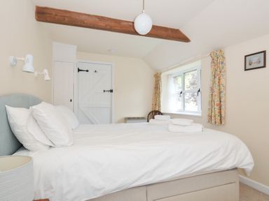 A bedroom with a bed and window at Mill Pond in Rock