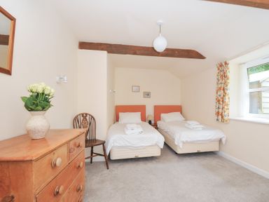 A bedroom with two beds and a dresser at Mill Pond in Rock