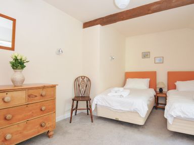 A bedroom with twin beds and a wooden dresser at Mill Pond in Rock