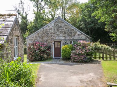 A house with a stone exterior and garden at Mill Pond in Rock