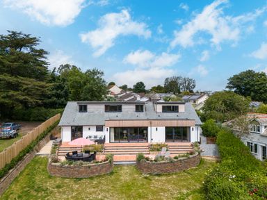 A house with a garden and outdoor seating area with umbrella at Porthilly Brook in Rock