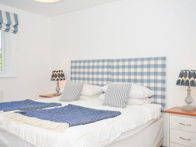 A bedroom with a bed and bedside lamps at Porthilly Brook in Rock