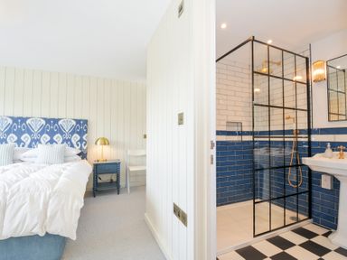 A bedroom with a bed and attached shower area at Porthilly Brook in Rock