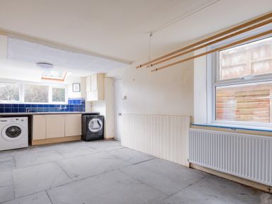 A utility room with washing machines countertops and cabinets at Pentire View (3) Polzeath