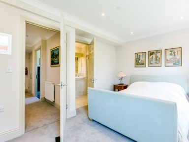 A bedroom with a light blue bed and three framed pictures above at Lowenna Manor 10 in Rock