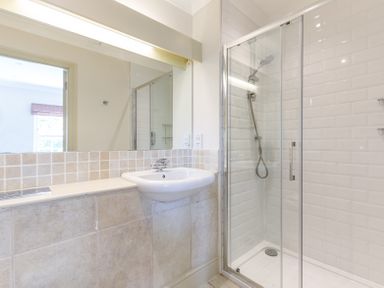 A bathroom with a sink and a glass-enclosed shower at Lowenna Manor 10 in Rock