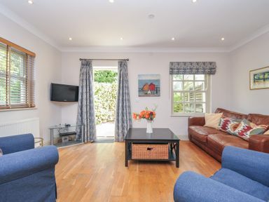 A living room with a television and seating area at Lowenna Manor 10 Rock