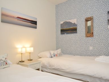 A bedroom with twin beds and lamps at The Point in Polzeath