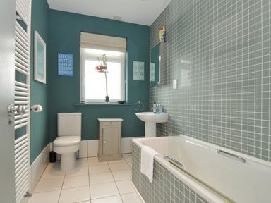 A bathroom with a sink, toilet, and bathtub at The Point in Polzeath