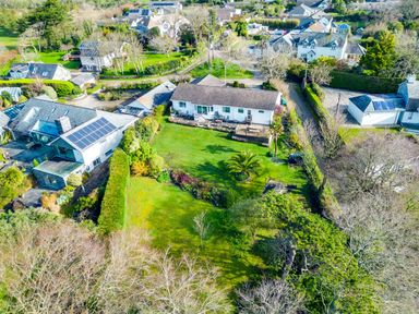 An aerial view of houses with gardens trees and solar panels at Rock Hill in Rock