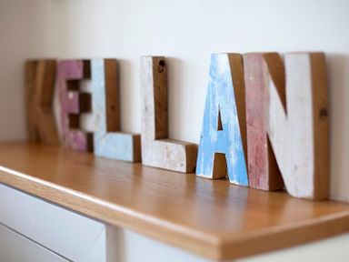 Wooden letters spelling KELLAN on a wooden surface at Kellan in Polzeath