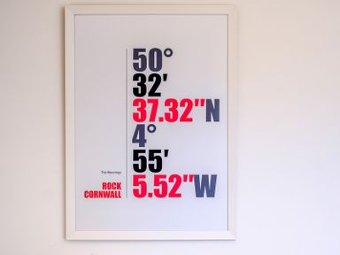 A framed print on a wall showing coordinates and text at The Moorings in Rock