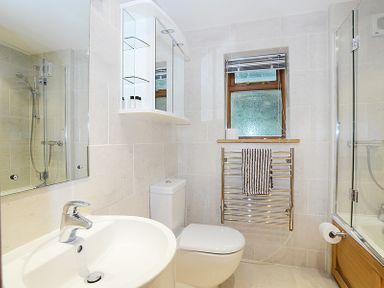 A bathroom with a sink toilet towel rack and shower at Sandy Hills 8 in Rock