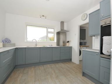 A kitchen with cabinets and a sink at Corriana in Rock