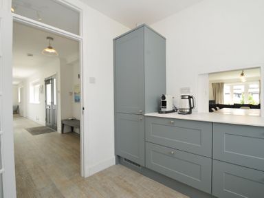 A kitchen with cupboards and appliances at Corriana in Rock