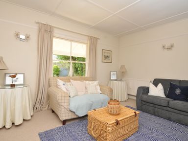 A living room with a sofa, armchair and coffee table at Sandy Lodge Rock