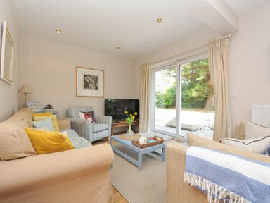 A living room with a television and coffee table at Sandy Lodge Rock