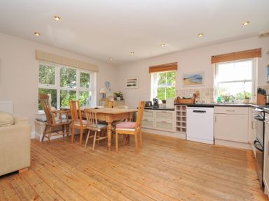 A kitchen with a table and chairs at Sandy Lodge Rock in Rock