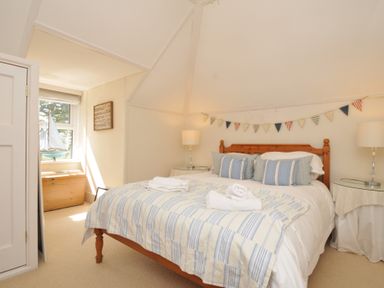 A bedroom with a bed and window at Sandy Lodge Rock in Rock