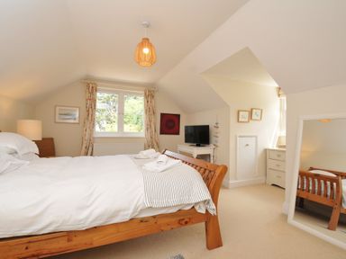 A bedroom with a bed and television at Sandy Lodge Rock