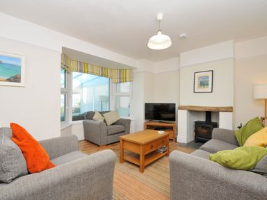A living room with sofa and coffee table at The Porthole in Port Isaac