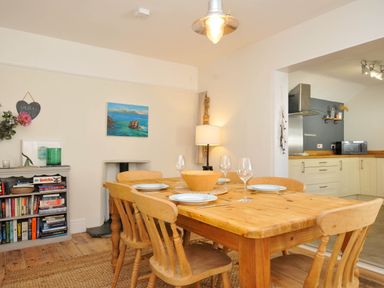 A dining room with a table and chairs at The Porthole in Port Isaac