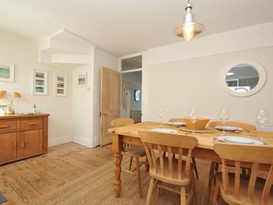 A dining room with a table and chairs at The Porthole in Port Isaac