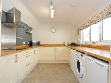A kitchen with appliances and a countertop at The Porthole in Port Isaac