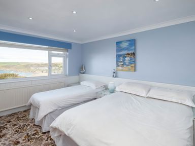 A bedroom with two beds and a view at Hillview in Polzeath