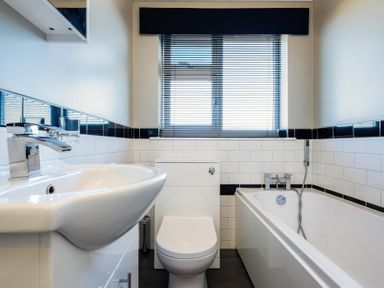 A bathroom with a sink, toilet, and bathtub at Hillview in Polzeath
