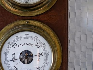 A barometer on a wooden surface at Hillview in Polzeath