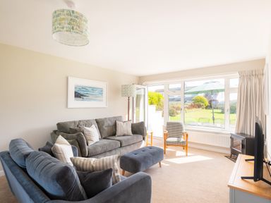 A living room with a sofa and armchair at Windyhill in Polzeath