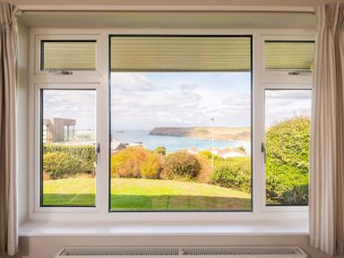A window showing a view of ocean and landscape at Windyhill in Polzeath