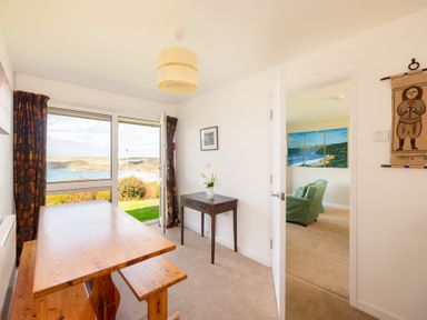 A dining room with a table and chairs at Windyhill in Polzeath