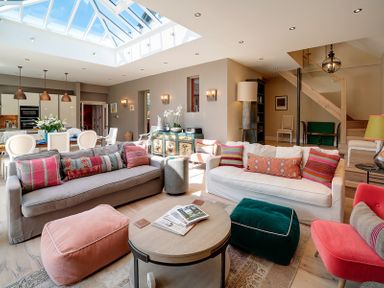 A living room with sofas and poufs under a skylight at Trevanion in Rock