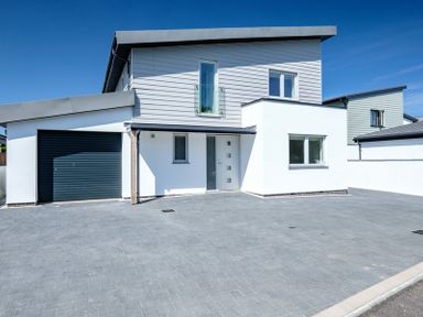 A modern two-story house with a garage and paved driveway at Artemis in Rock