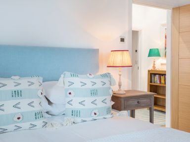 A bedroom with pillows on a bed and a bedside table with a lamp at Artemis in Rock