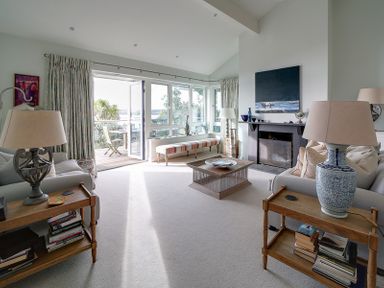 A living room with sofas lamps a coffee table and a fireplace at Camel Point in Rock