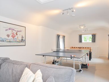 A game room with foosball and ping pong tables at Orchard Cottage Polzeath